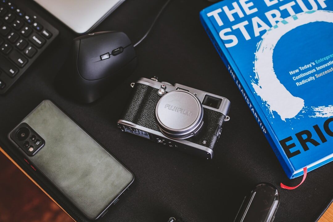 Camera equipment and notebook on a wooden table