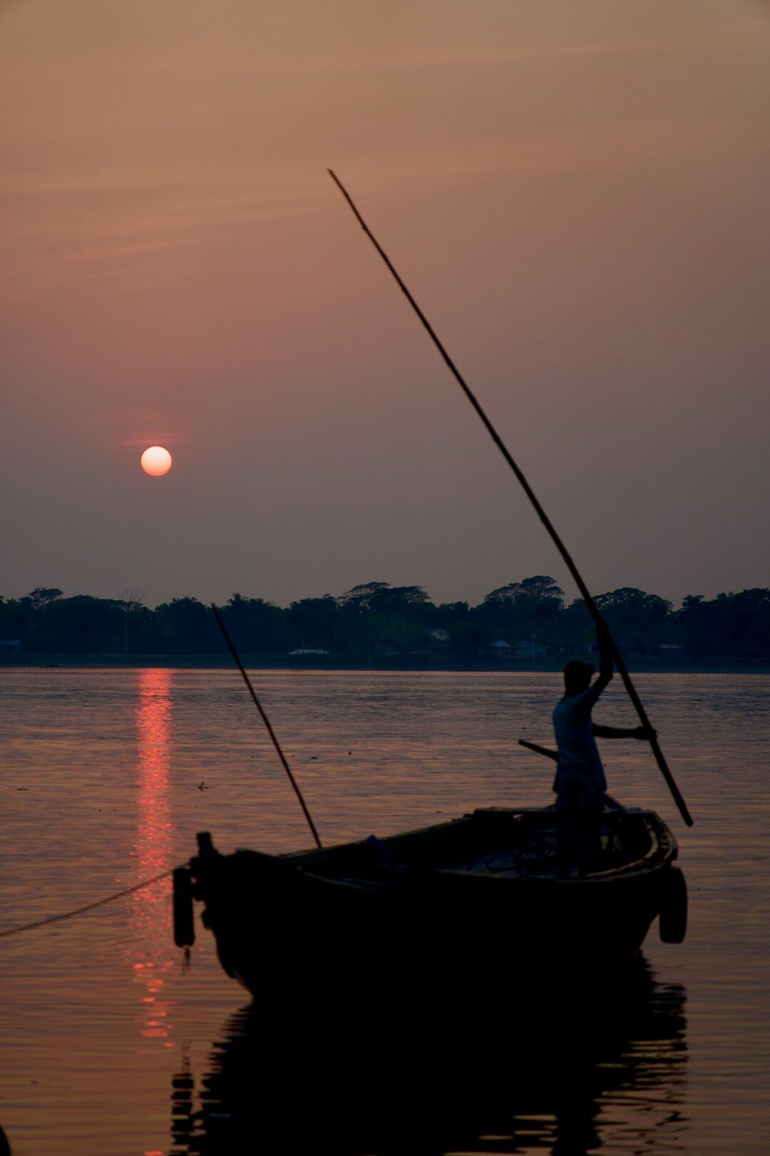 fisherman on boat at dawn