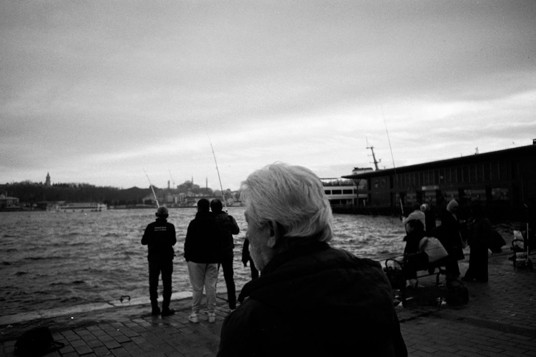 elderly men talking by harbor